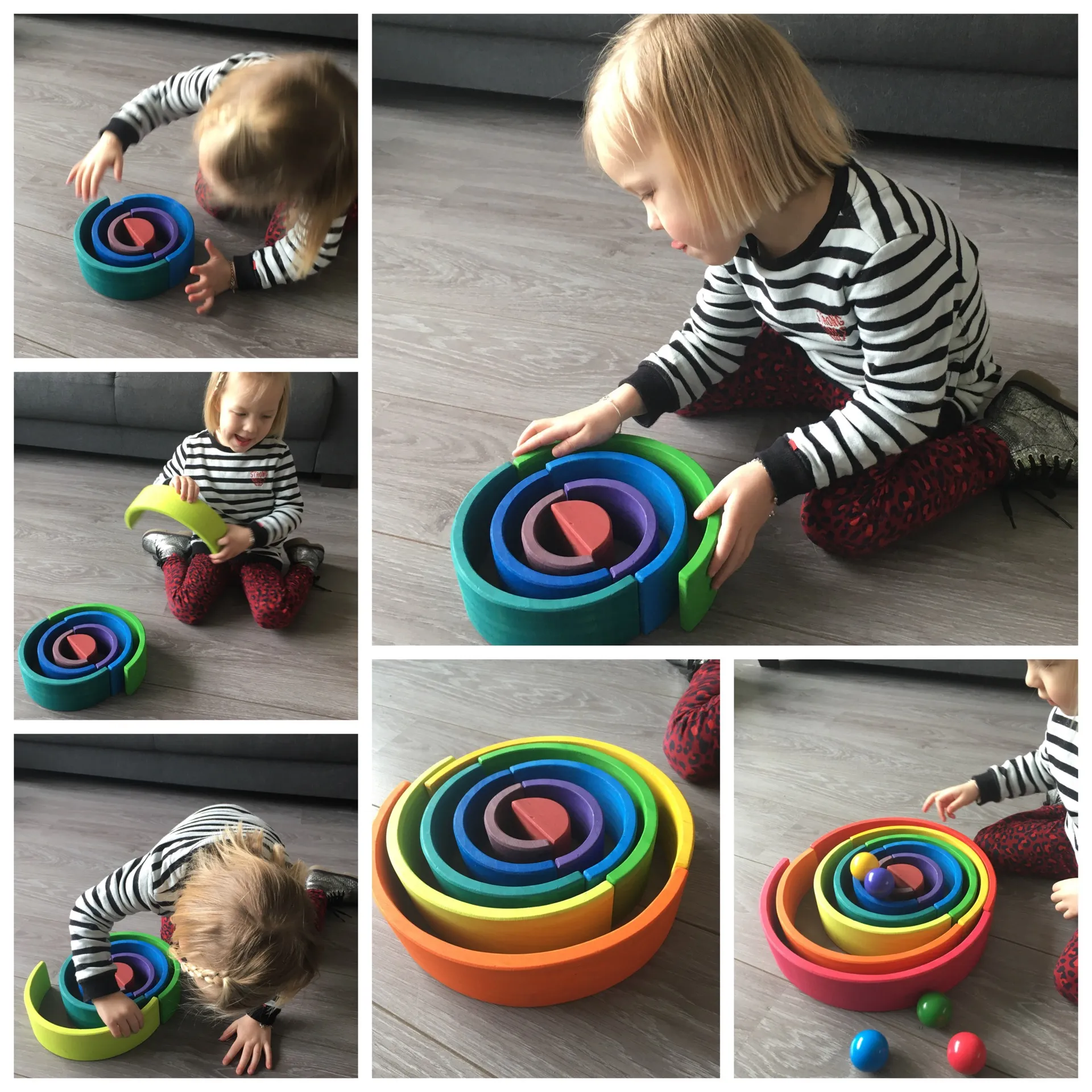 Drie jarig meisje bouwt knikkerbaan met houten bogen.